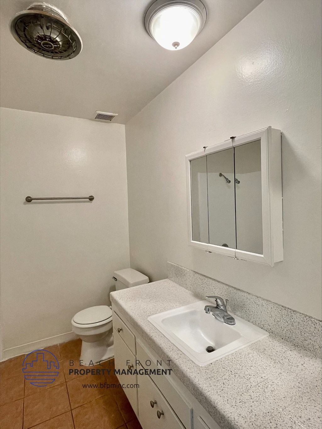 an empty bathroom with a sink and a toilet